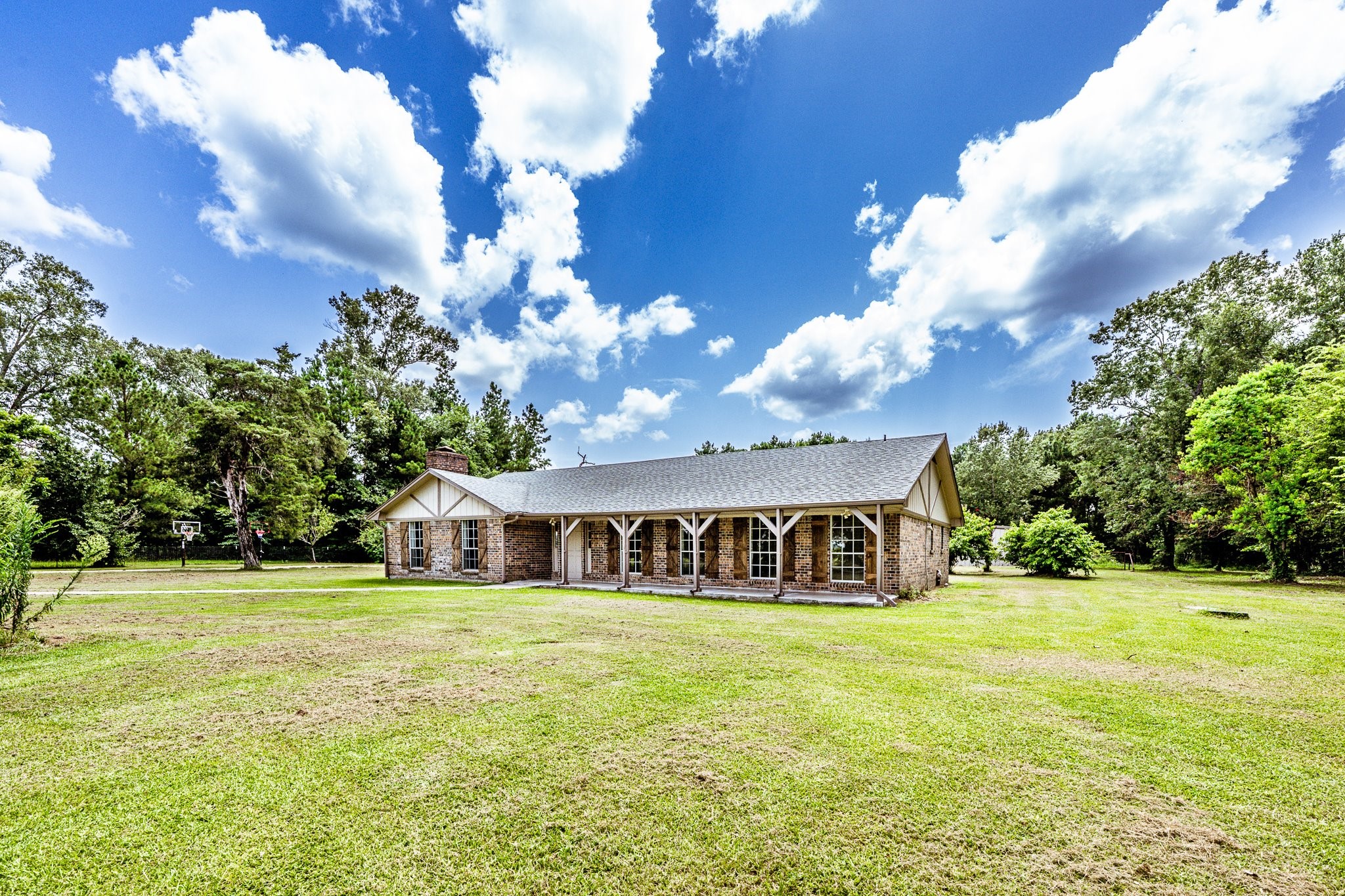 92 Mt Zion Road New Waverly, TX 77358 - Photo 17 of 33 a front view of a house with garden and trees
