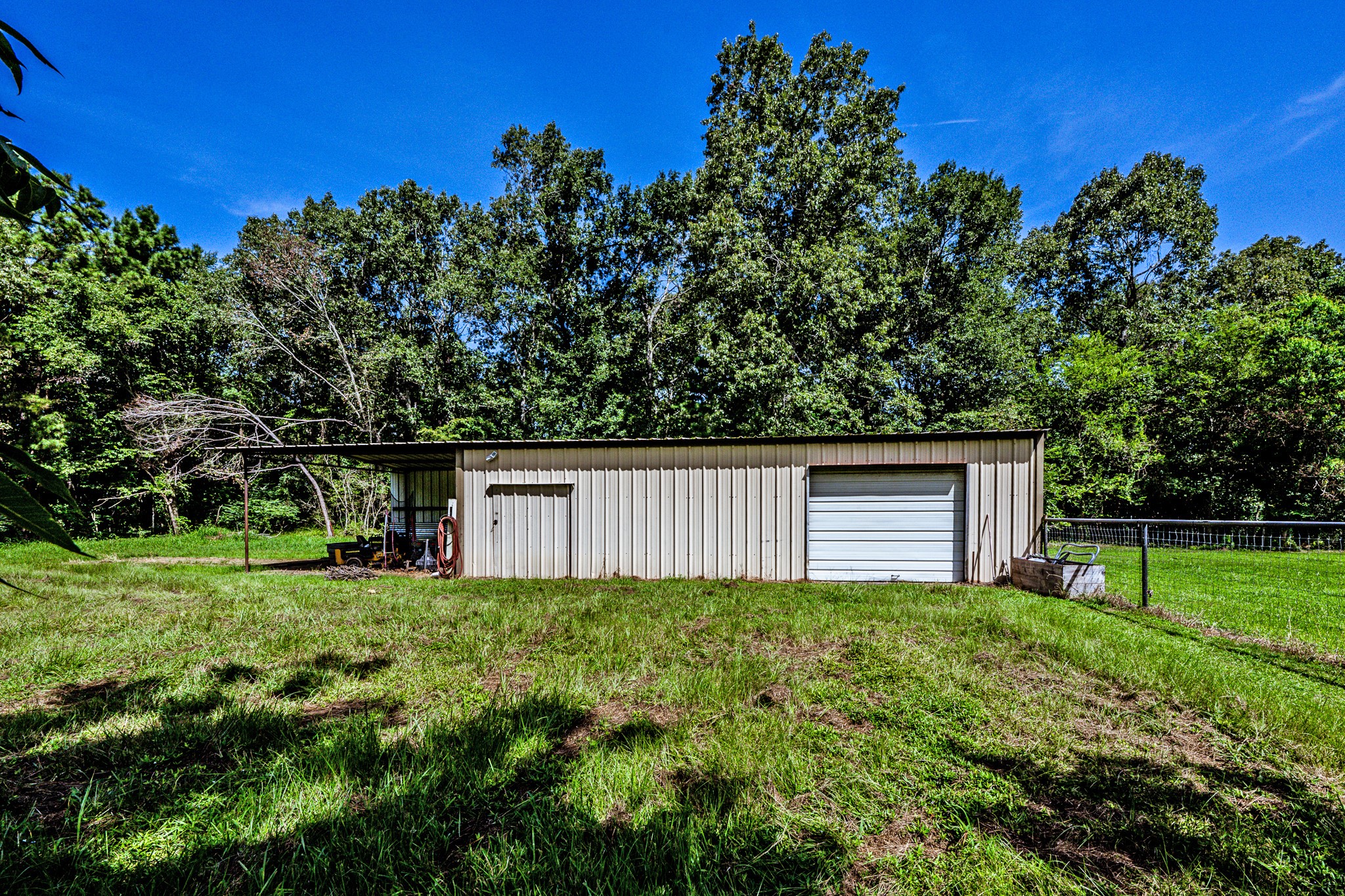 92 Mt Zion Road New Waverly, TX 77358 - Photo 20 of 33 a house with green field in front of it