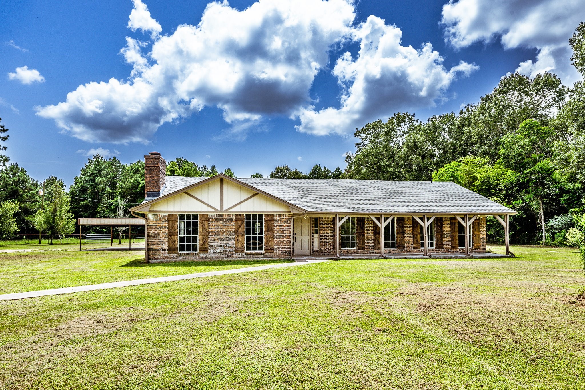 92 Mt Zion Road New Waverly, TX 77358 - Photo 29 of 33 a front view of a house with garden and trees