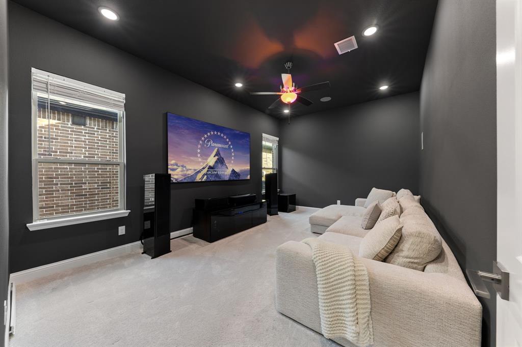 8808 Royal Star Road Rowlett, TX 75089 - Photo 32 of 40 a living room with furniture and a flat screen tv
