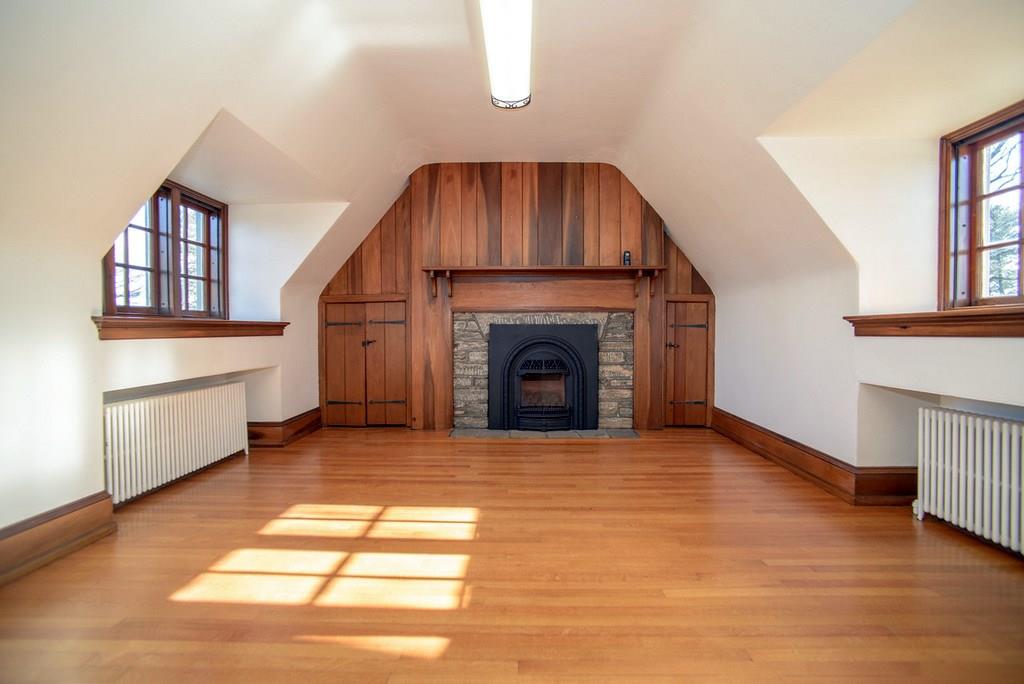 899 Persimmon Road Sewickley Heights, PA 15143 - Photo 20 of 25 Upper level family room; fireplace with stone hearth with new gas burner and remote control, hardwood flooring; task fluorescent lighting