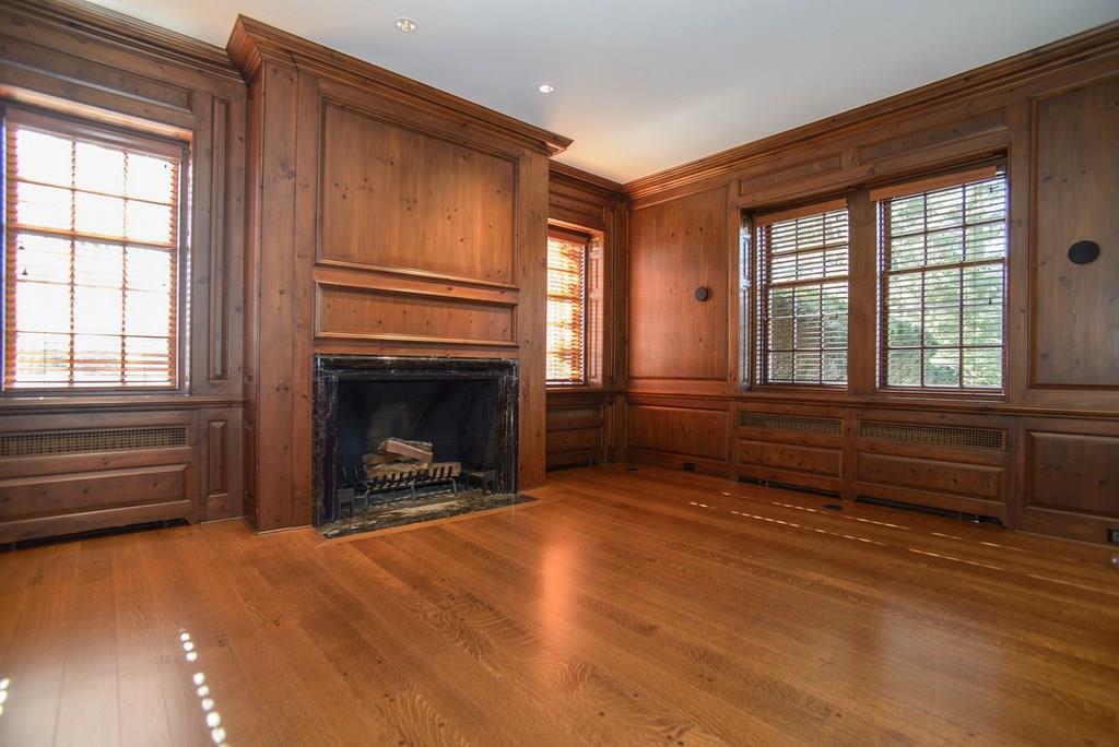 899 Persimmon Road Sewickley Heights, PA 15143 - Photo 8 of 25 Paneled library with wood burning fireplace, new matching wooden blinds, and Tiger's Eye Oak flooring