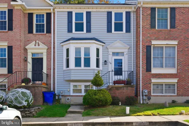 a front view of a house with yard and green space