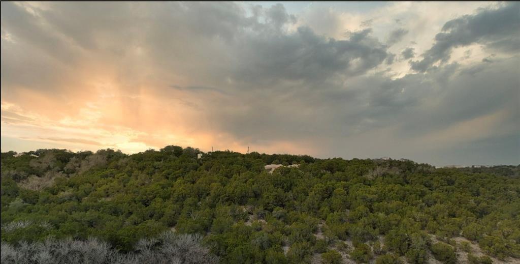 20802 Tejas Trail Lago Vista, TX 78645 - Photo 2 of 6 a view of a big yard of mountains and valleys