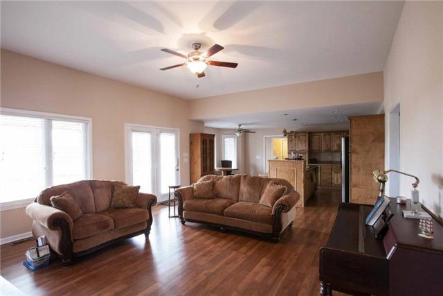 Great room is open to kitchen and has a door leading to the screened porch. 