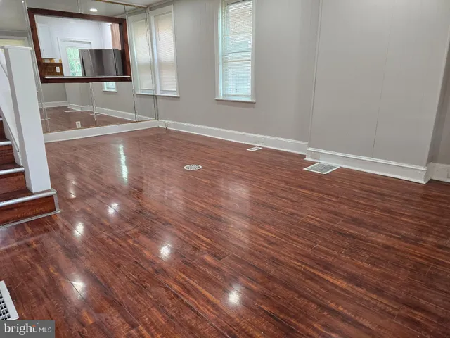 a view of a room with wooden floor