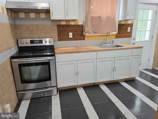 a kitchen with a sink stove and cabinets