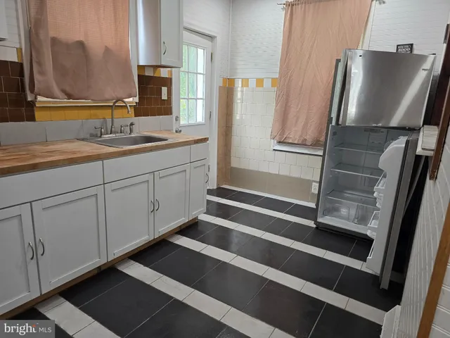 a bathroom with a double vanity sink and mirror