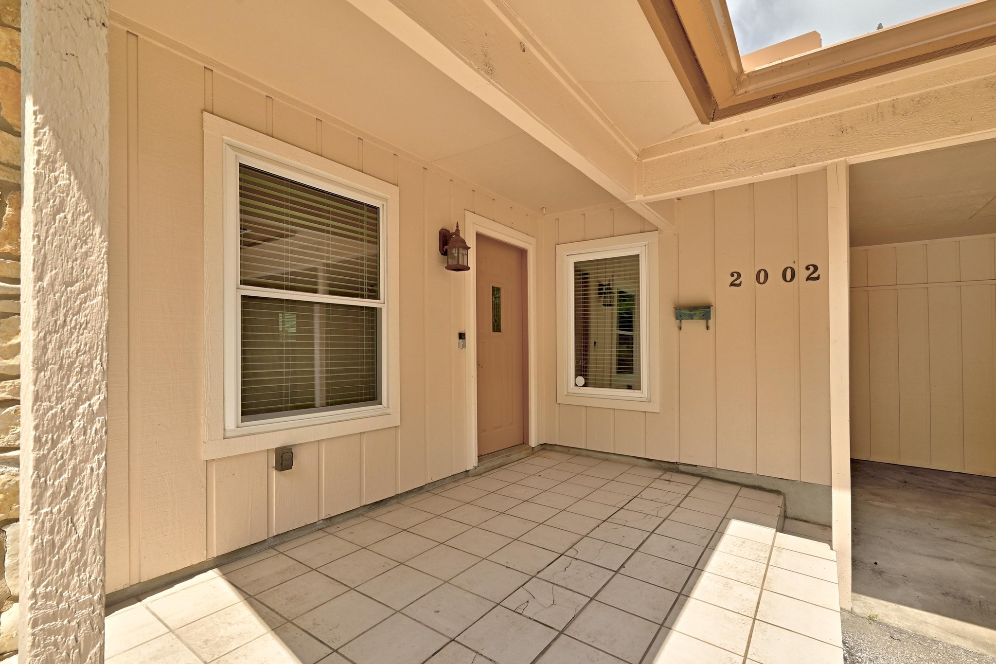 2002 Rabb Road Austin, TX 78704 - Photo 5 of 25 A welcoming covered entry features durable tile flooring and board and batten siding.