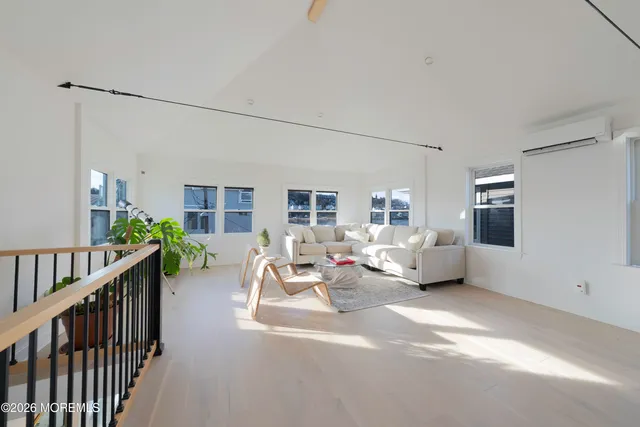a view of a balcony with wooden floor and iron fence
