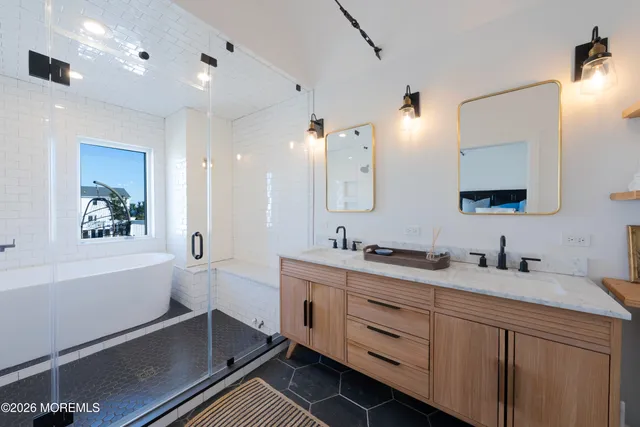 a bathroom with a double vanity sink toilet and mirror
