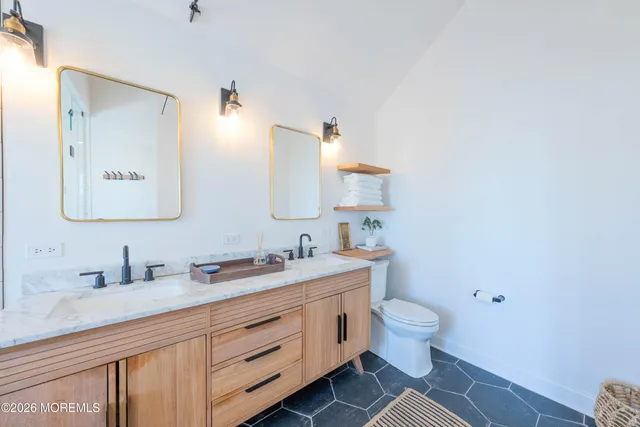 a large bathroom with a glass door shower and sink