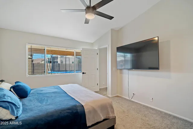 a bedroom with a bed and a couch