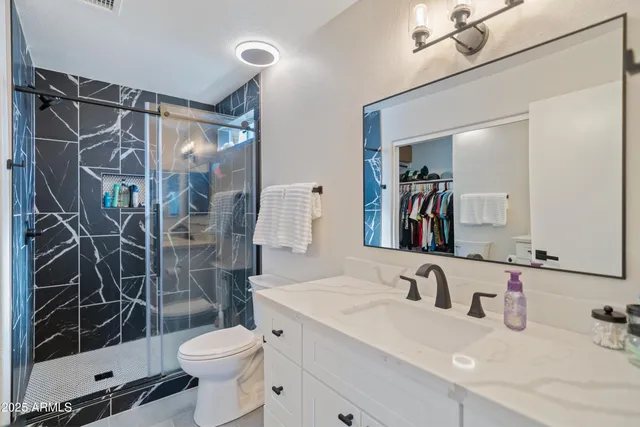 a bedroom with a large bed and a flat screen tv