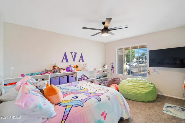 a bedroom with bed and a chandelier