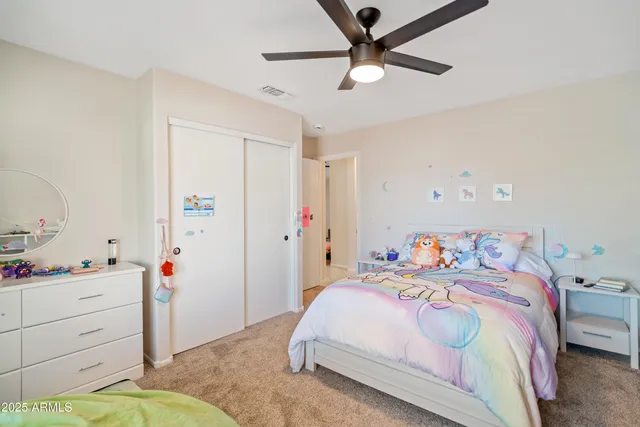 a bedroom with two beds and a window