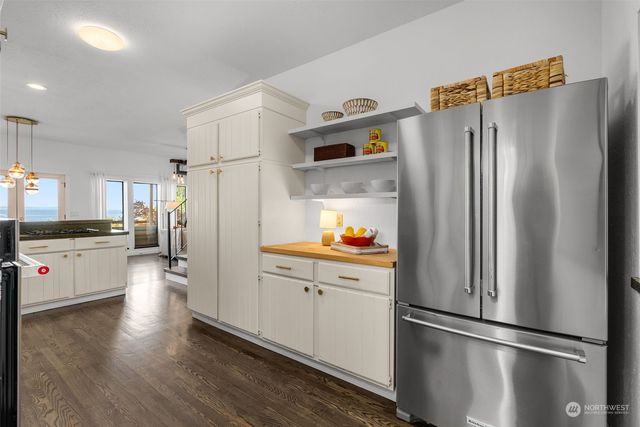 a kitchen with stainless steel appliances a refrigerator and a stove top oven