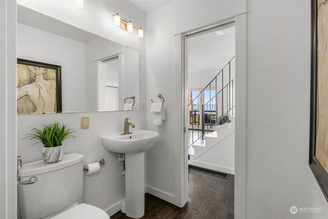 a bathroom with a sink toilet and a mirror