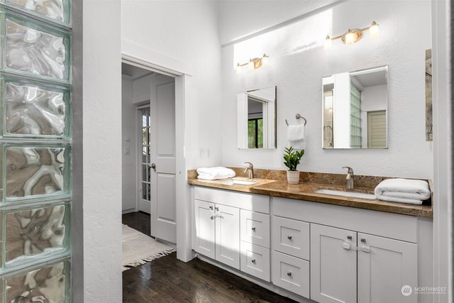 a bathroom with a granite countertop sink mirror and double