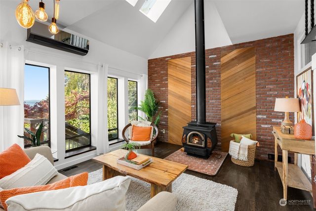 a living room with furniture and a floor to ceiling window