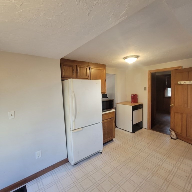 50 Pine Ridge Road Weymouth, MA 02189 - Photo 9 of 20 a kitchen with refrigerator and white cabinets