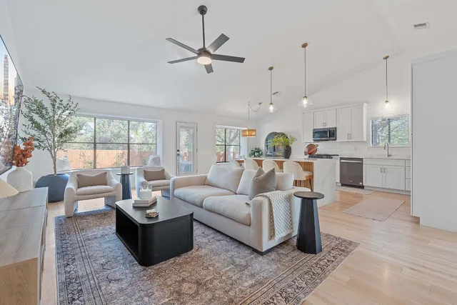 a view of a house with a yard and large tree