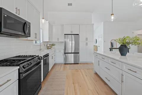 a living room with furniture and a wooden floor