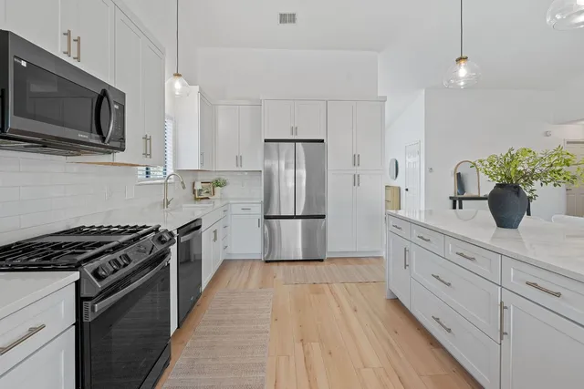 a living room with furniture and a wooden floor