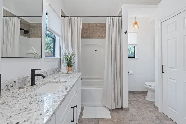 a spacious bedroom with a bed and window