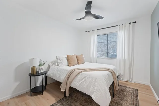 a bathroom with a granite countertop sink a toilet and shower
