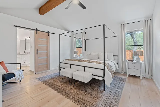 a kitchen with stainless steel appliances granite countertop a dining table chairs refrigerator and sink