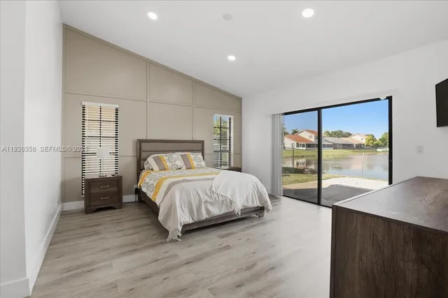 a spacious bedroom with a bed and a large window