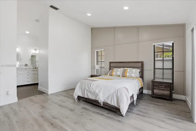 a bedroom with a bed and a view of kitchen
