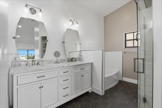 a spacious bathroom with a granite countertop sink a mirror and a