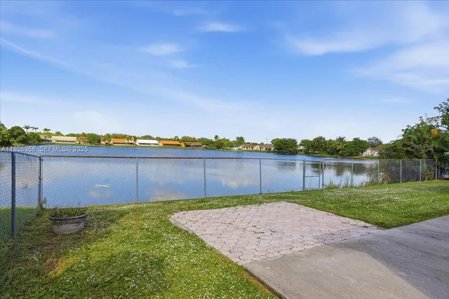 a view of a backyard with a lake view