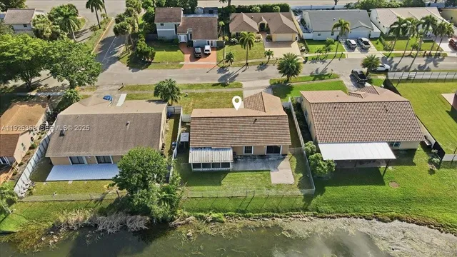 an aerial view of a house with a garden and yard