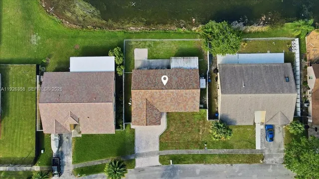 an aerial view of a house with swimming pool outdoor seating and yard