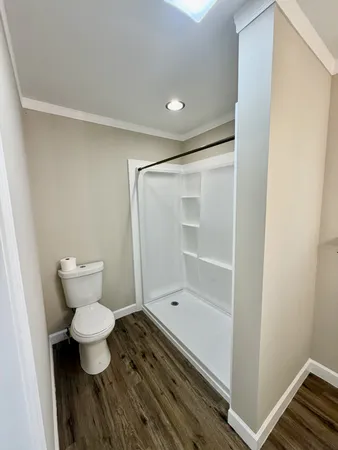 a bathroom with a toilet and a shower