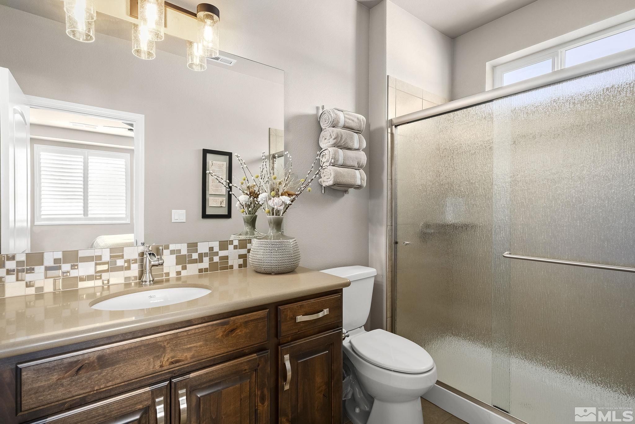 2173 Berkich Court Reno, NV 89521 - Photo 11 of 29 a bathroom with a granite countertop sink toilet and shower