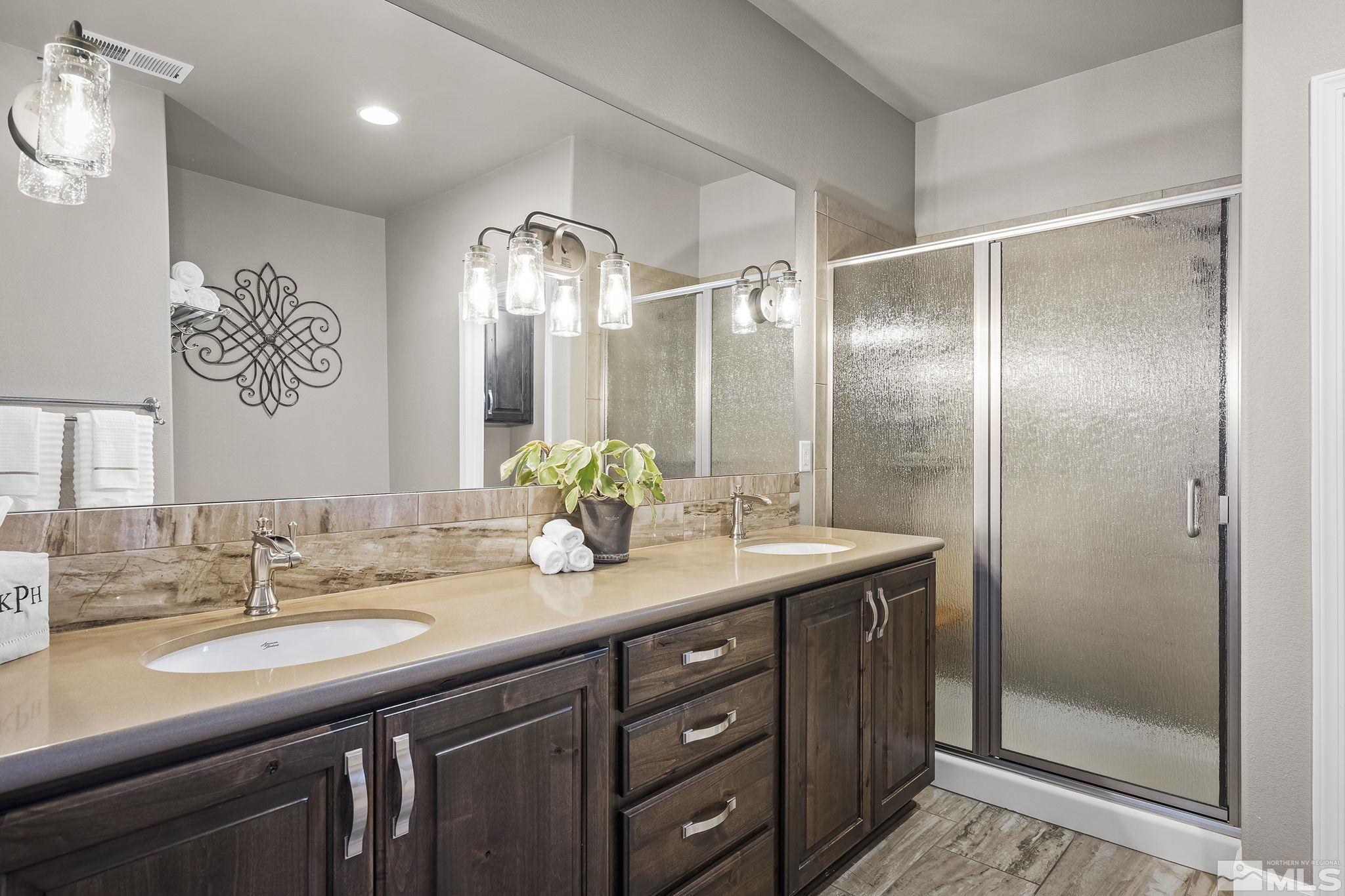 2173 Berkich Court Reno, NV 89521 - Photo 9 of 29 a bathroom with a double vanity sink and a mirror