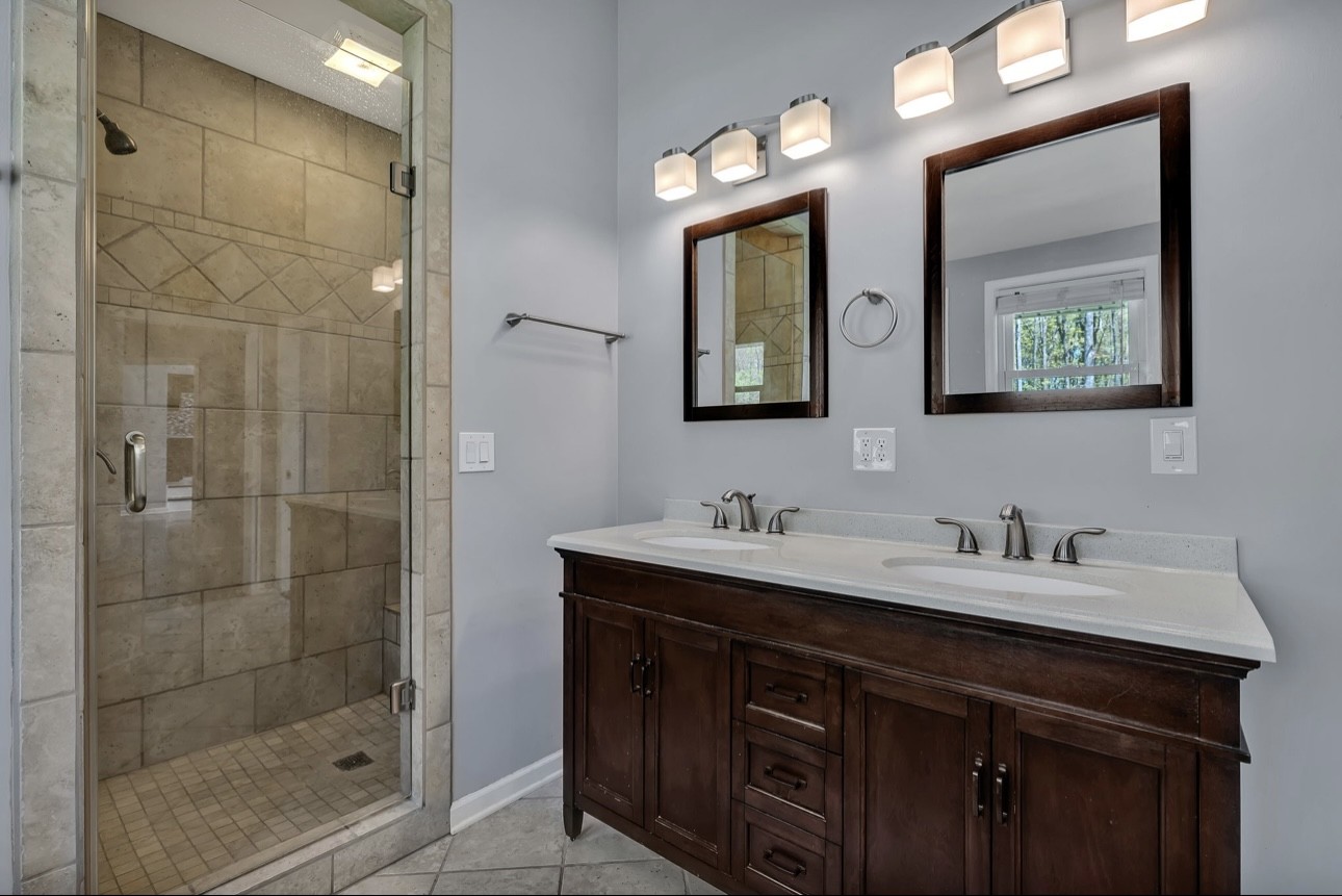 1104 Deer Ridge Road Kingston Springs, TN 37082 - Photo 13 of 36 a bathroom with double sink and a mirror