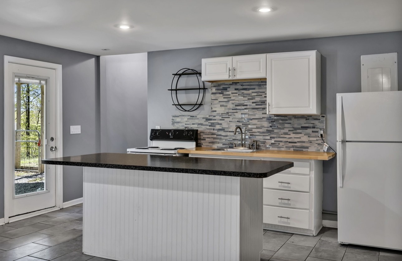 1104 Deer Ridge Road Kingston Springs, TN 37082 - Photo 17 of 36 a kitchen with kitchen island a sink stainless steel appliances and cabinets