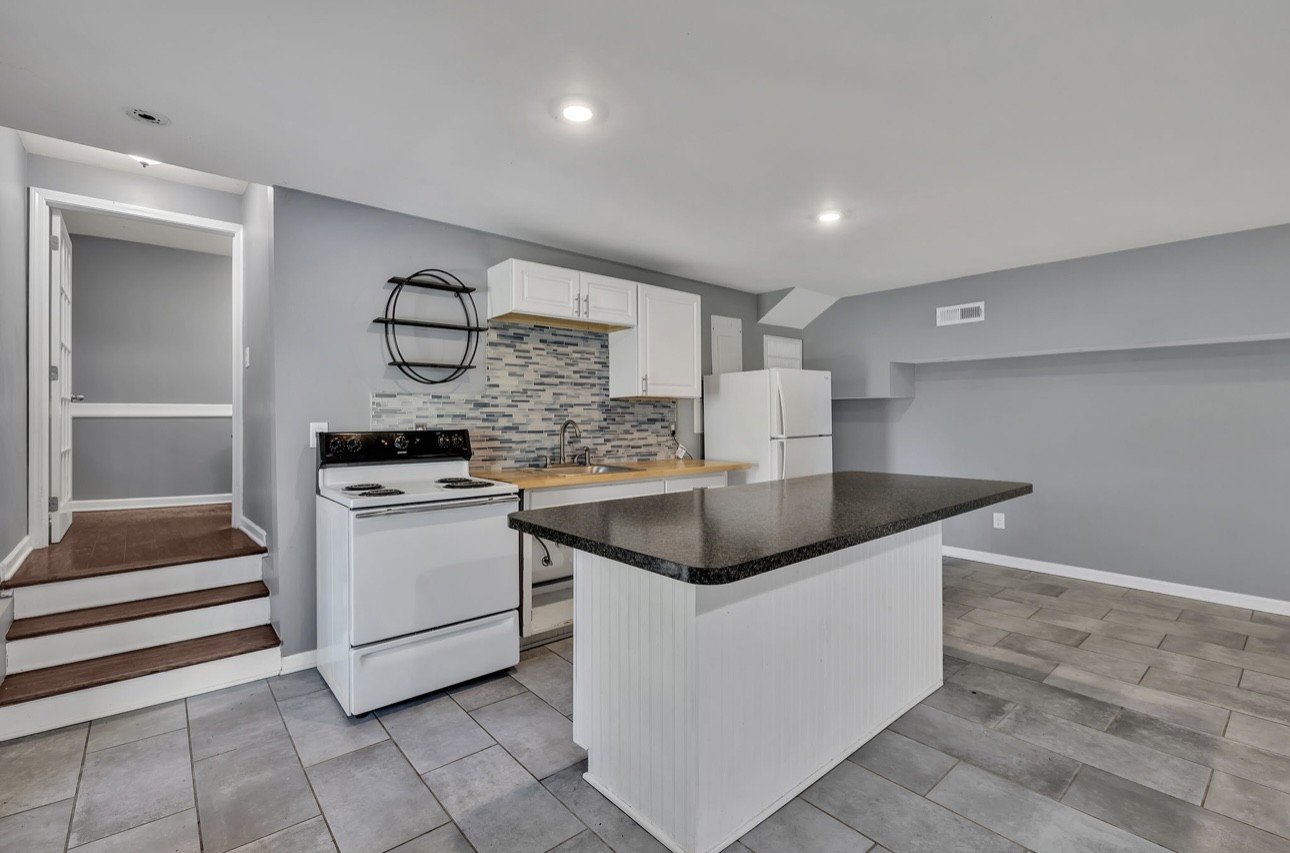1104 Deer Ridge Road Kingston Springs, TN 37082 - Photo 18 of 36 a kitchen with stainless steel appliances granite countertop a sink and a stove top oven