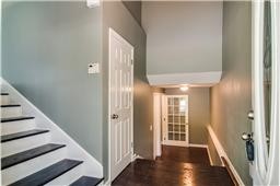 1104 Deer Ridge Road Kingston Springs, TN 37082 - Photo 31 of 36 a view of a hallway with wooden floor and staircase