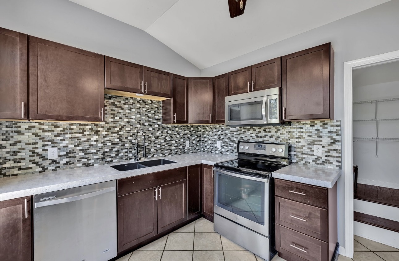 1104 Deer Ridge Road Kingston Springs, TN 37082 - Photo 8 of 36 a kitchen with stainless steel appliances a stove sink and microwave