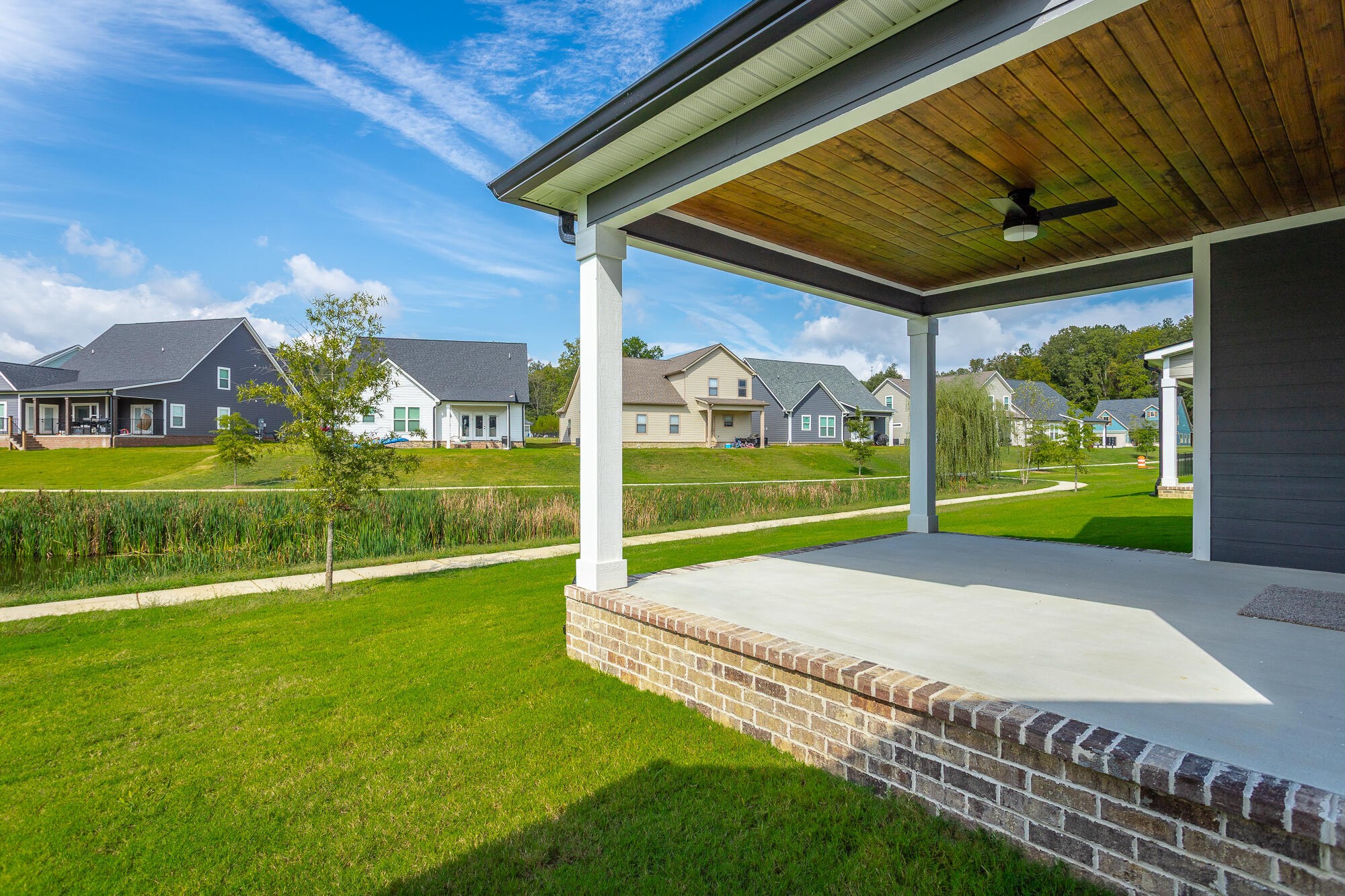 364 Willow Grv Court, Unit 67 Ringgold, GA 30736 - Photo 12 of 78 a view of a backyard with table and chairs under an umbrella