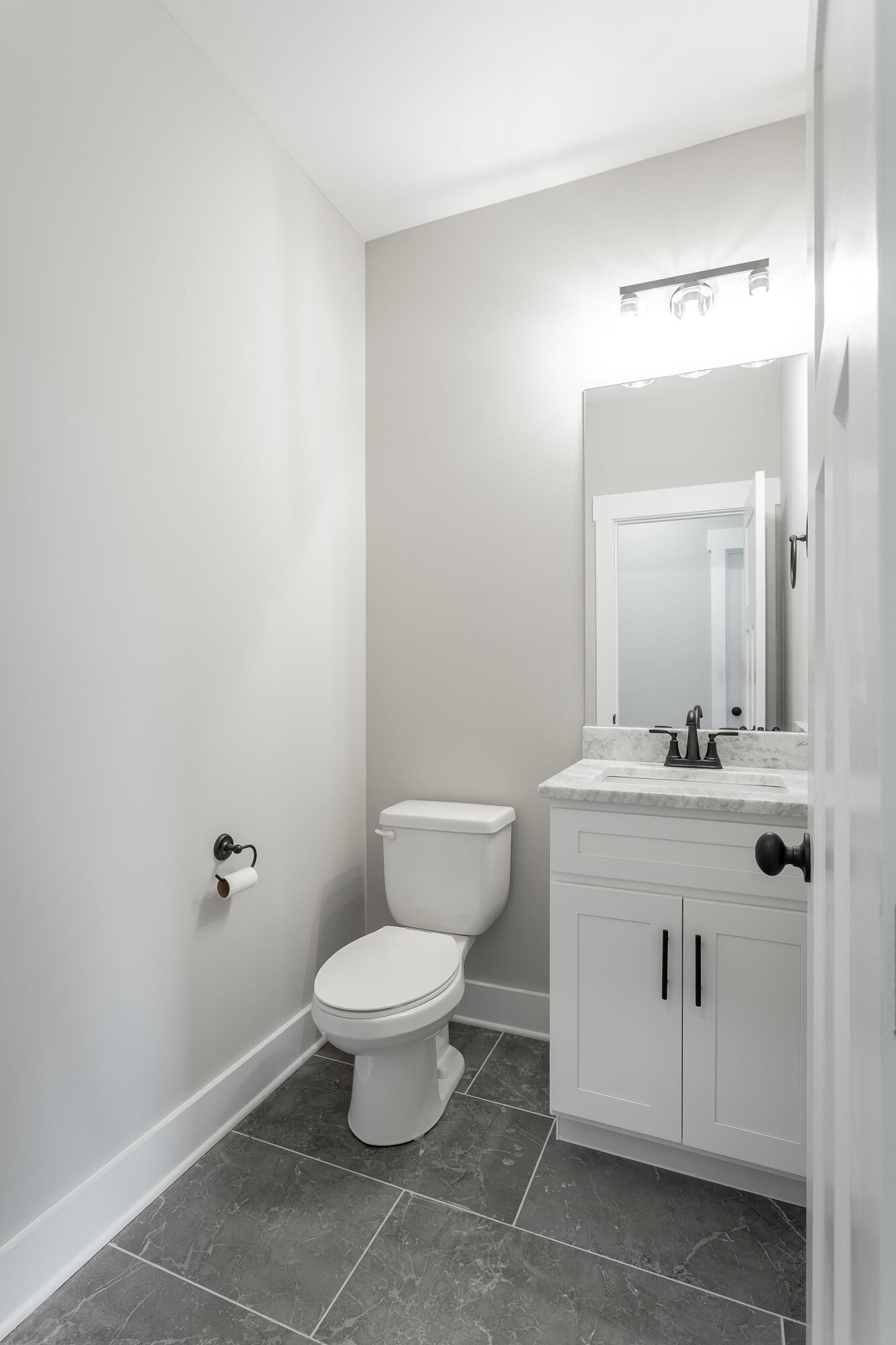 364 Willow Grv Court, Unit 67 Ringgold, GA 30736 - Photo 39 of 78 a bathroom with a granite countertop toilet a sink and mirror