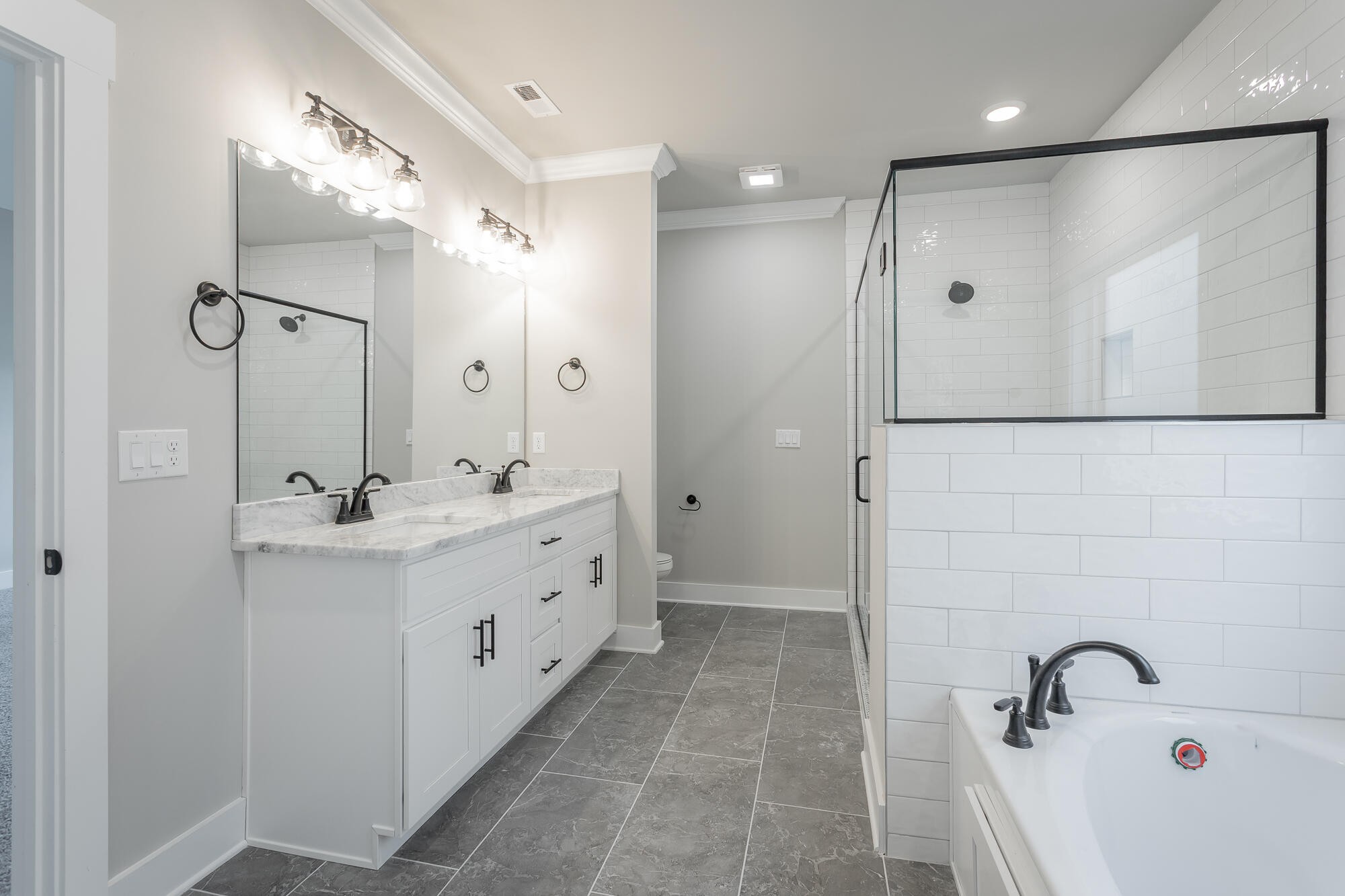 364 Willow Grv Court, Unit 67 Ringgold, GA 30736 - Photo 47 of 78 a bathroom with a double vanity sink a mirror and a shower