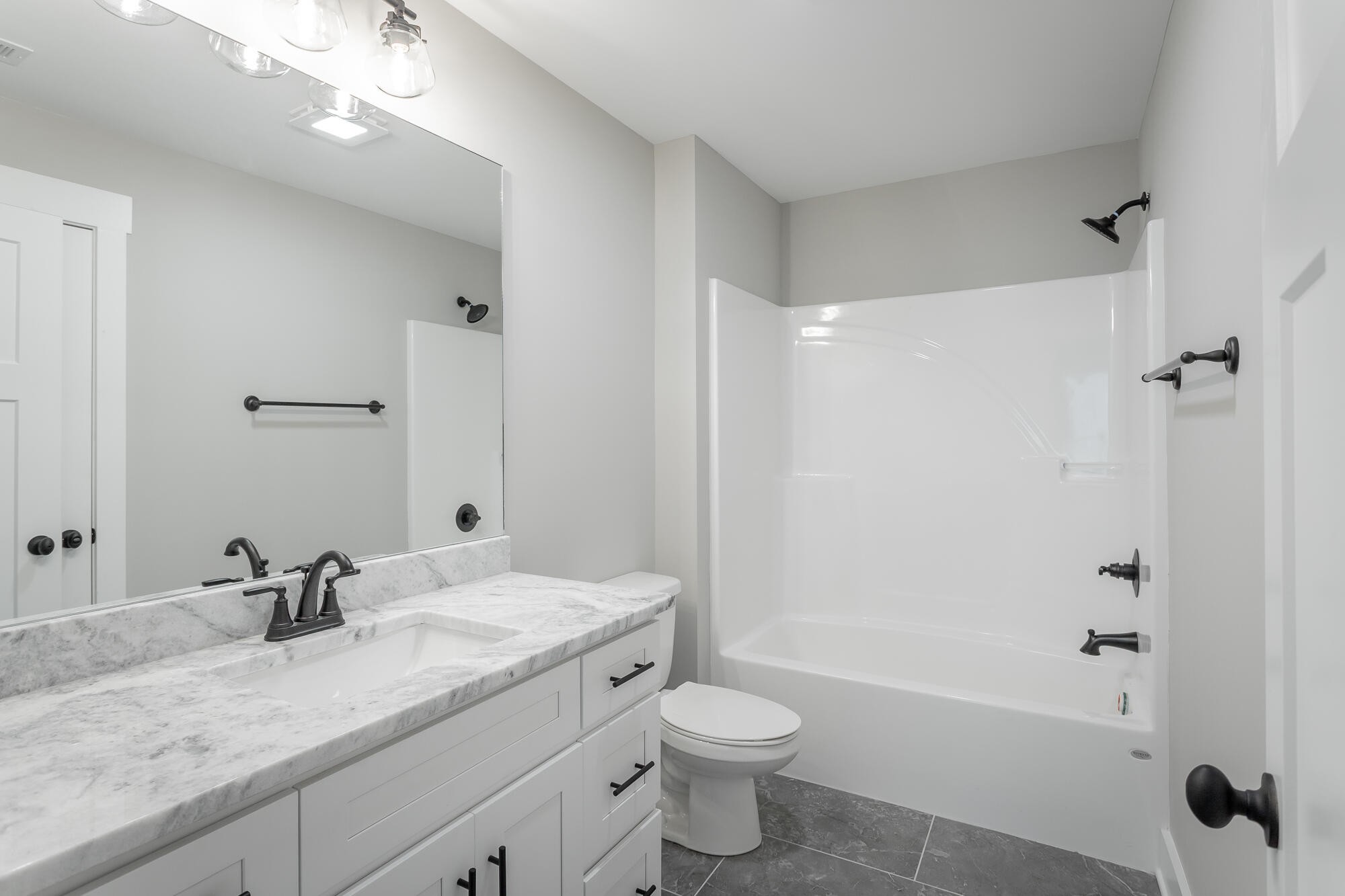 364 Willow Grv Court, Unit 67 Ringgold, GA 30736 - Photo 61 of 78 a bathroom with a granite countertop sink a toilet and shower