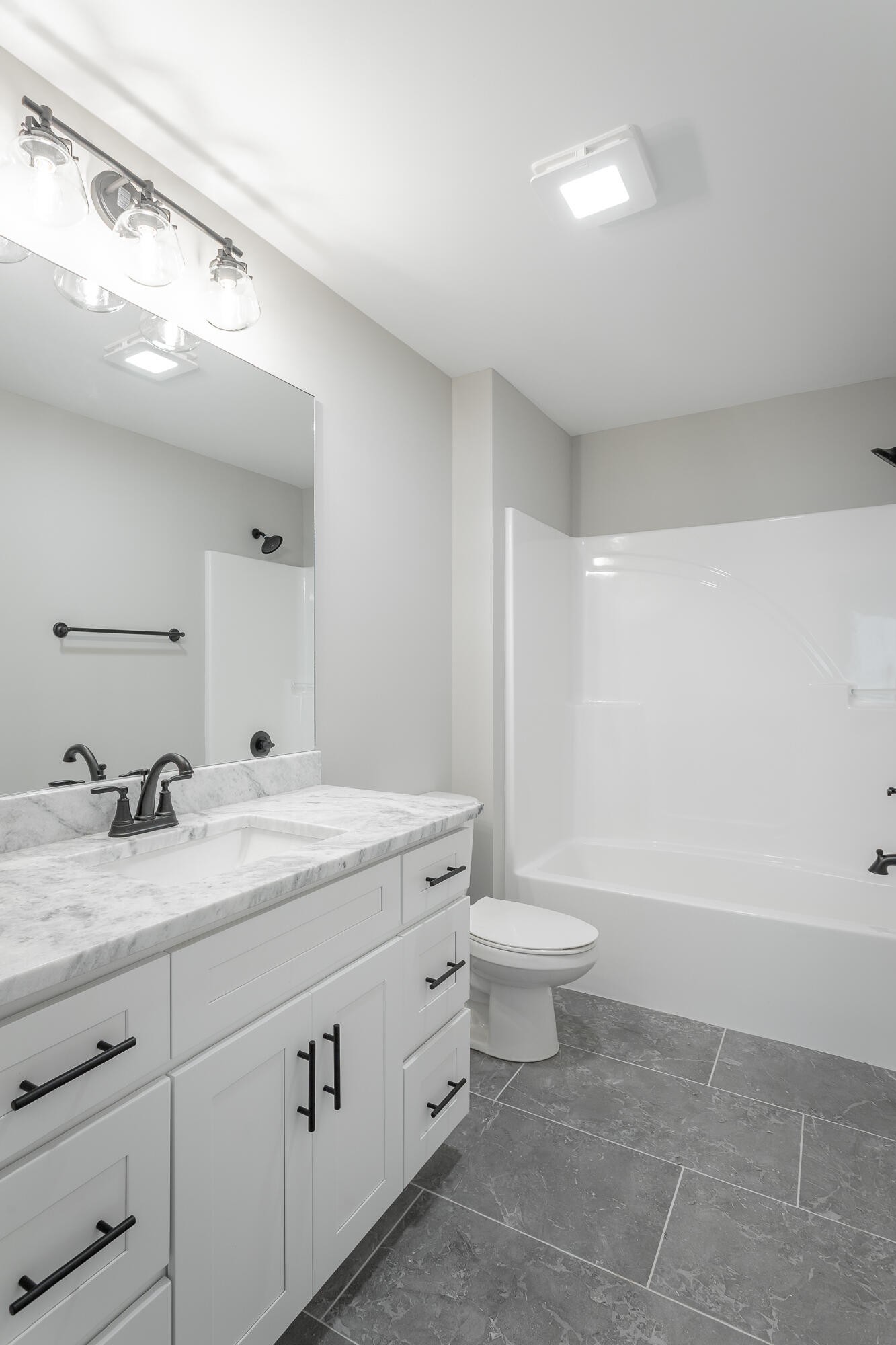 364 Willow Grv Court, Unit 67 Ringgold, GA 30736 - Photo 62 of 78 a spacious bathroom with a granite countertop sink a toilet a mirror and bathtub